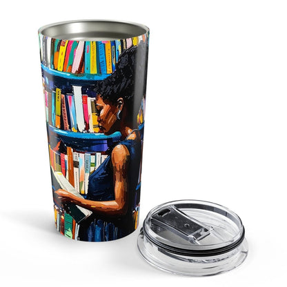 Black woman with a book in her hand as she stands before a bookcase. Scholar, library, bookstore vibe.