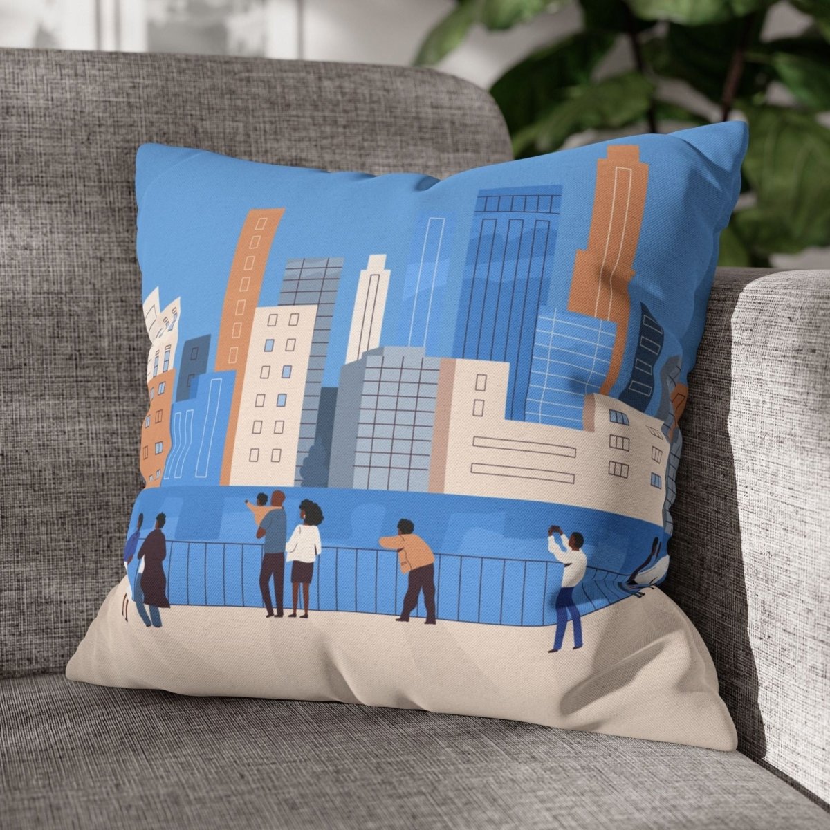 Decorative pillow with cityscape design on a gray couch