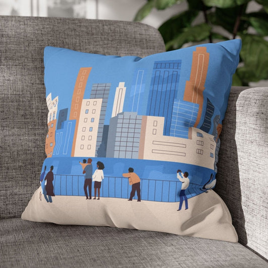 Decorative pillow with cityscape design on a gray couch