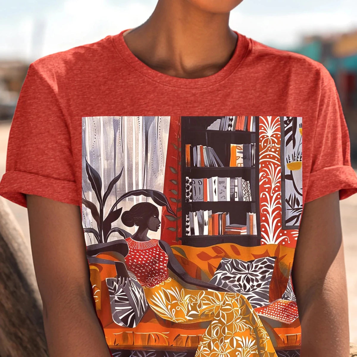 Adult unisex t-shirt featuring a Black woman lounging gracefully on an orange living room couch, surrounded by a rich tapestry of patterns, a tall bookshelf, and lush houseplants.