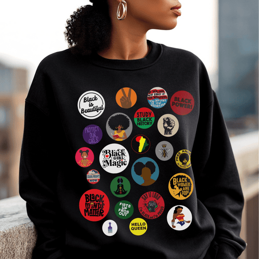Sweatshirt with button-style designs celebrating Black culture, featuring phrases, symbols, and illustrations in a grid.