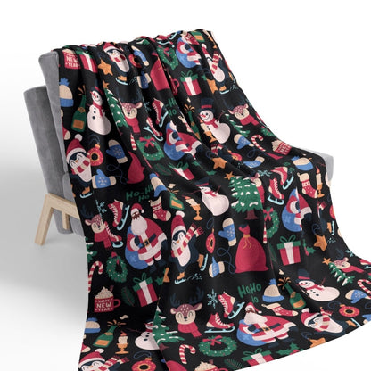 Christmas-themed blanket with colorful patterns draped over a chair on a white background