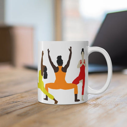 Mug with brown women of different shades doing various yoga poses while wearing chakras colors.